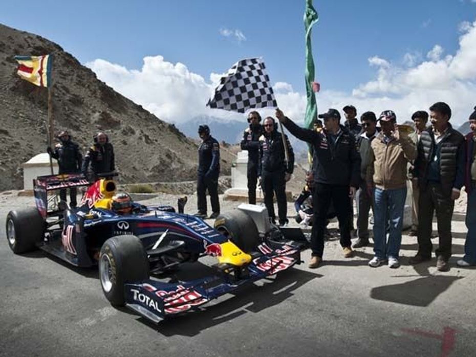 Omar Abdullah flags off the Red Bull Racing car driven by Neel Jani