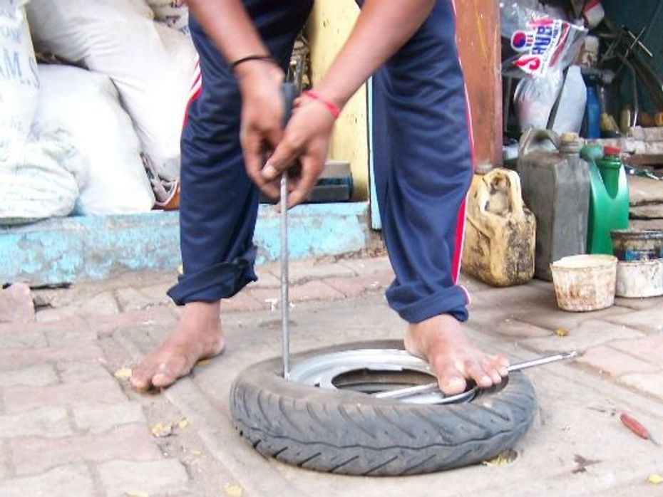 Use the tyre iron to remove the tyre