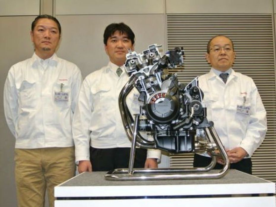 Honda officials posing with the new 400cc motor