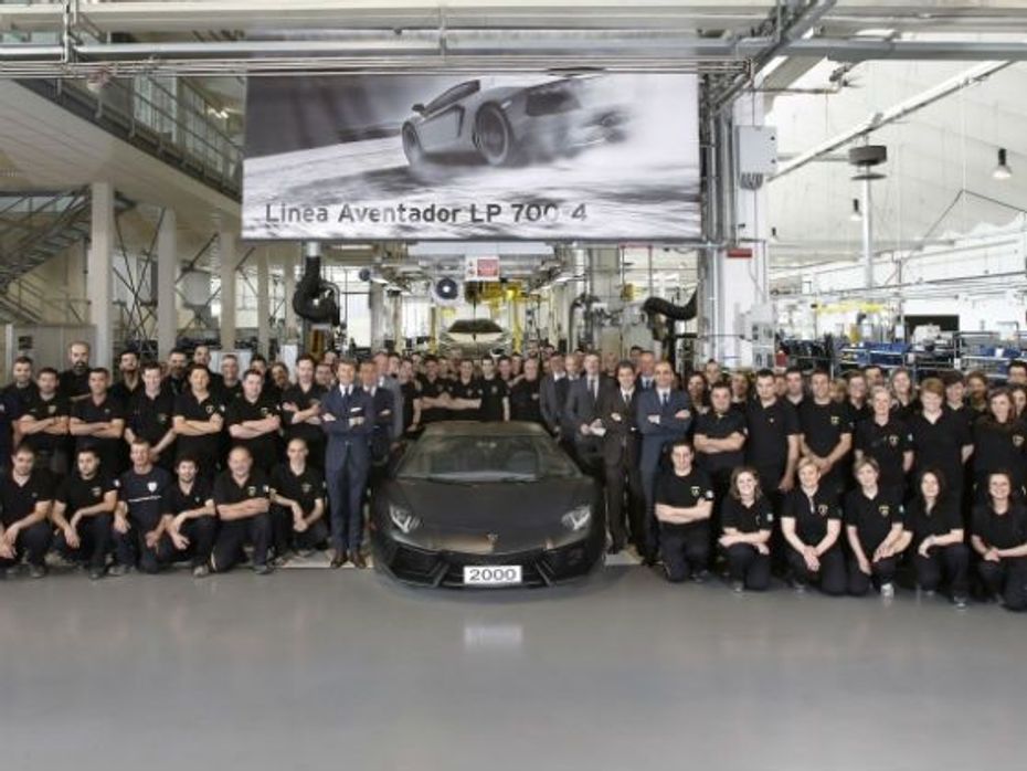 Lamborghini officials pose with the 2,000th Aventador on the assembly line