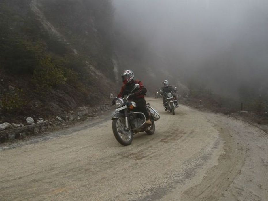 Riders making their way through fog