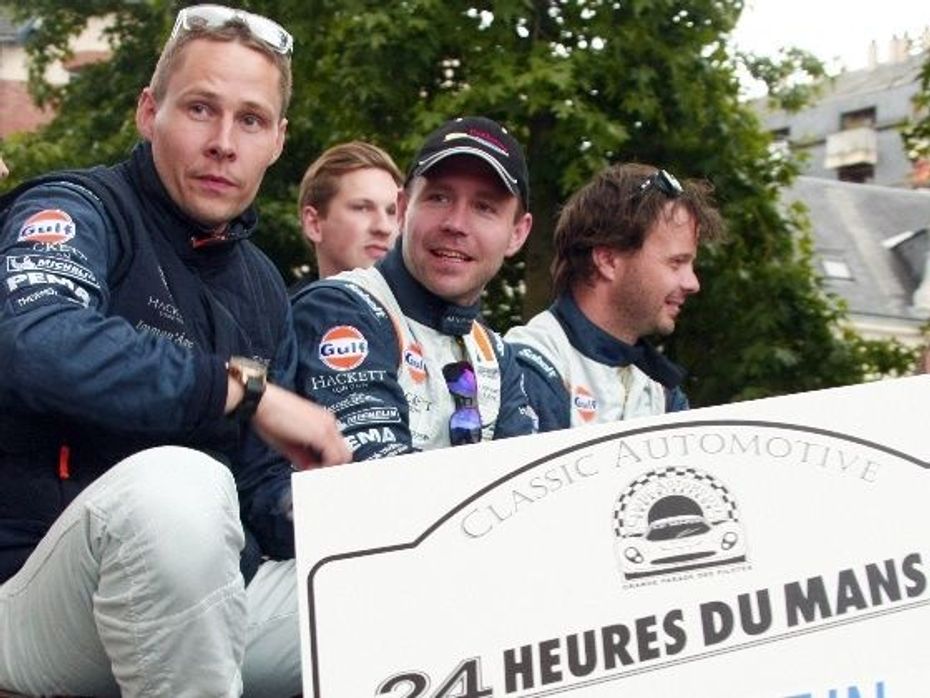 Allan Simonsen, left, is seen during a parade with his team mates a day before the Le Mans 24-hour race