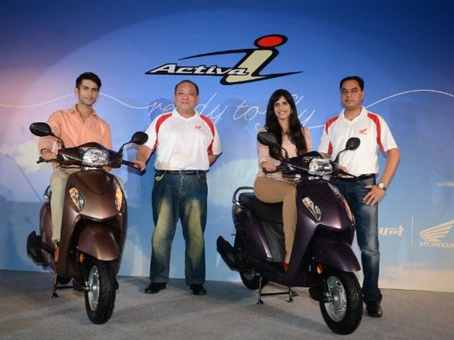 Honda officials pose with the Activa-i at its launch
