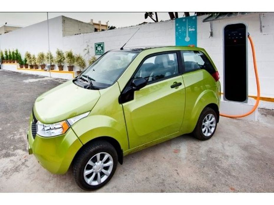Mahindra Reva e2o electric car hooked to a charging station