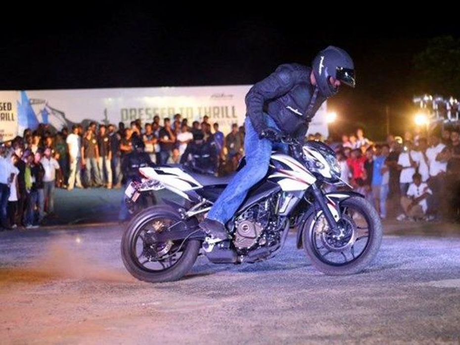 A rider performs stunt on the Bajaj Pulsar 200NS