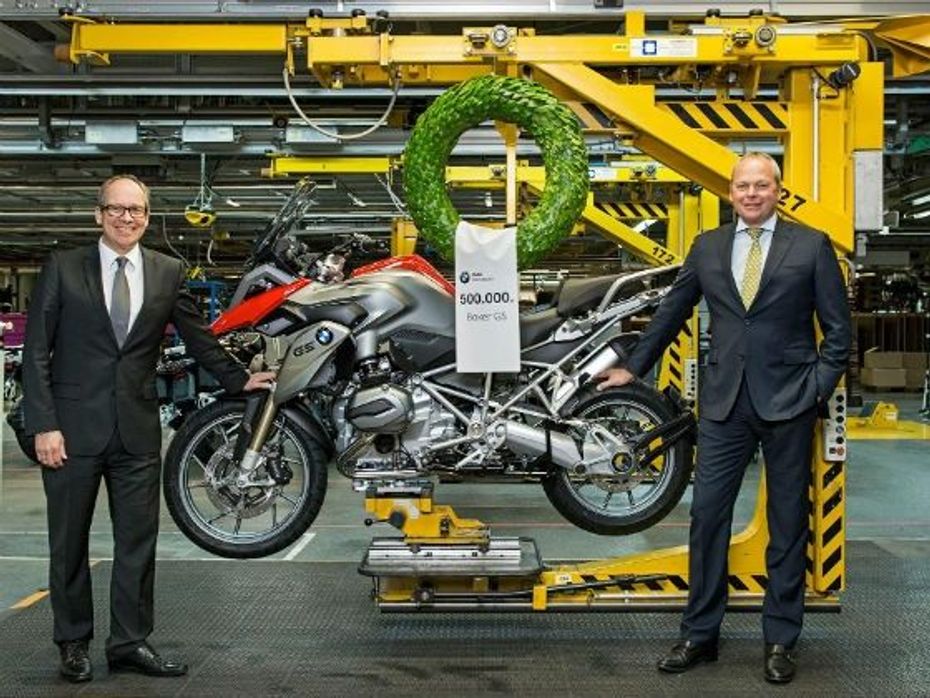 BMW officials pose with the 5,00,000th boxer-twin GS series motorcycle