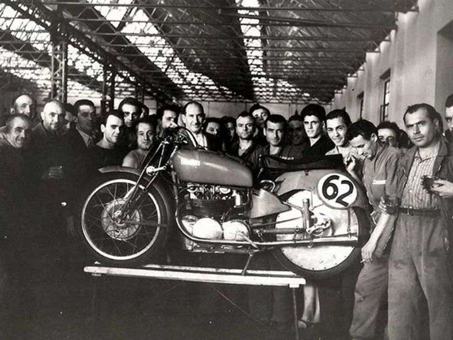 Old picture of Benelli engineers with a motorcycle at company workshop situated in Italy