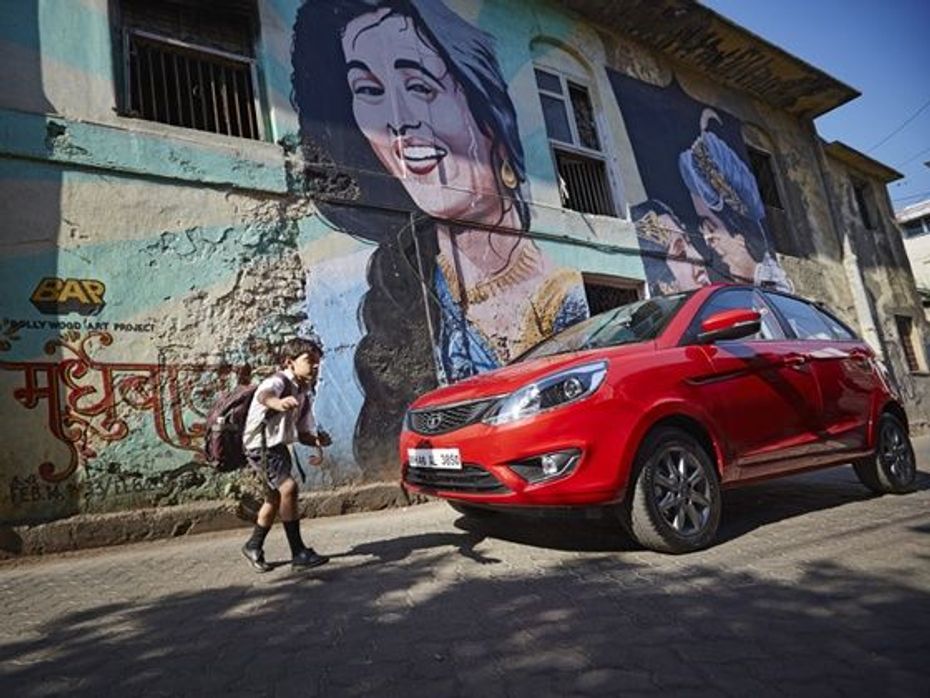 Tata Bolt Quadrajet parked in front of a wall with Bollywood graffiti