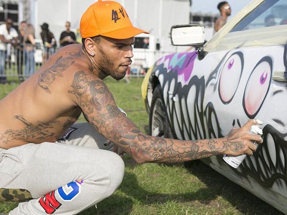 Chris Brown spray paints car for charity