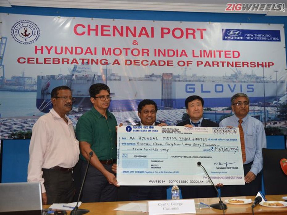 Cyril C. George handing over the cheque to YK Koo