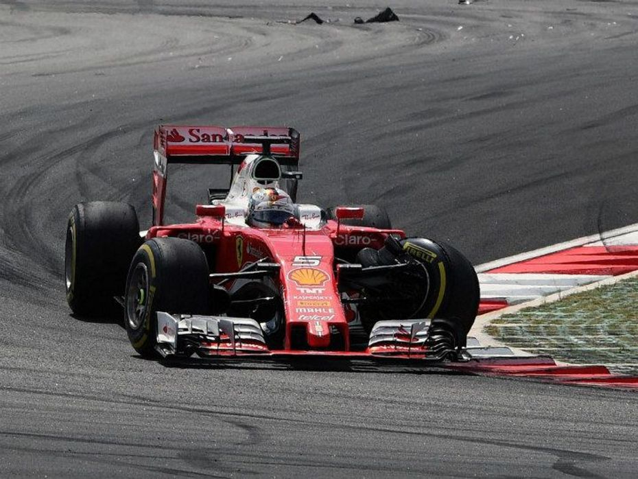 Vettel with his car damaged from the front-left side