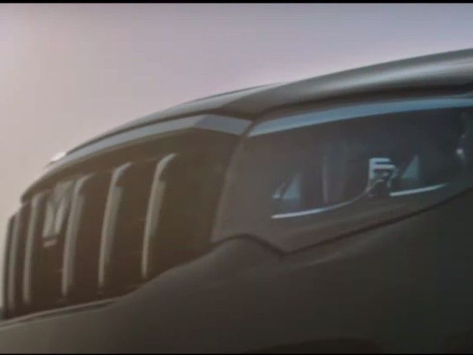 Mahindra Scorpio teaser showing grille, headlight and company logo