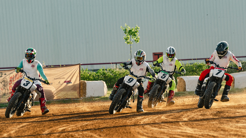 Finalists sliding around the first corner