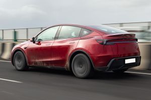 Driving: Rear Left Three Quarter View Image of Model Y