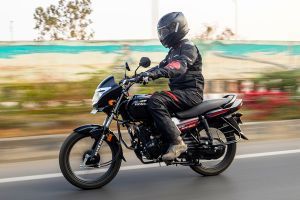 Riding: Front Left Quarter View of Shine 100 DX