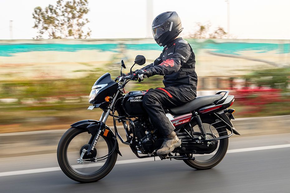 Riding: Front Left Quarter View of Shine 100 DX
