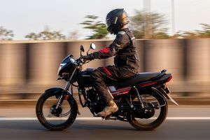 Riding: Left Side Profile View of Shine 100 DX