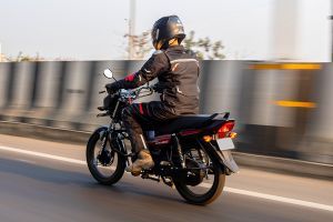 Riding: Rear Left 3/4 View of Shine 100 DX