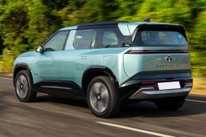 Driving: Rear Left Three Quarter View Image of Sierra EV