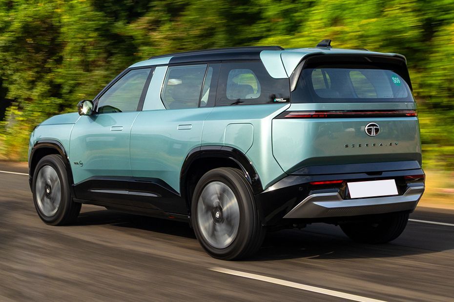 Driving: Rear Left Three Quarter View Image of Sierra EV