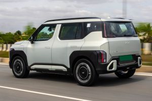 Driving: Rear Left Three Quarter View Image of Syros EV