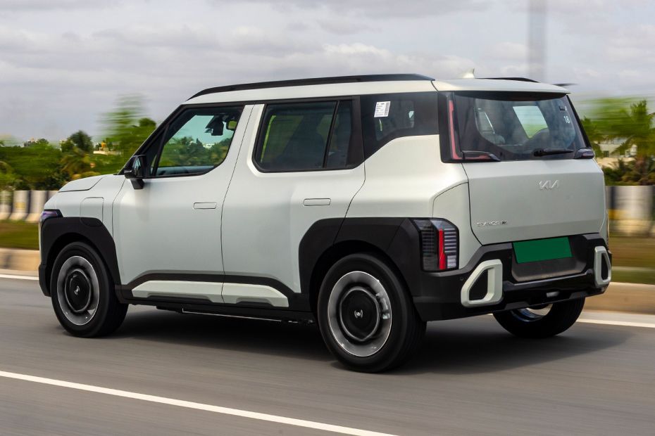 Driving: Rear Left Three Quarter View Image of Syros EV