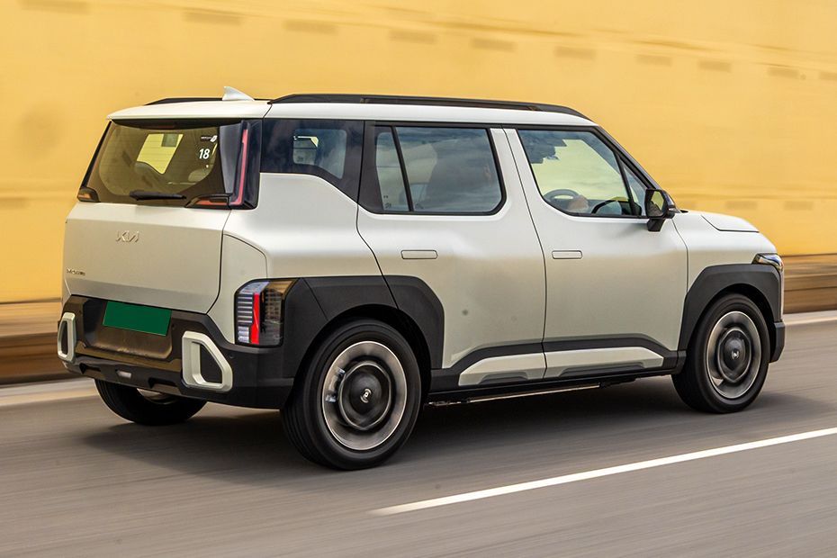 Driving: Rear Right Three Quarter View Image of Syros EV