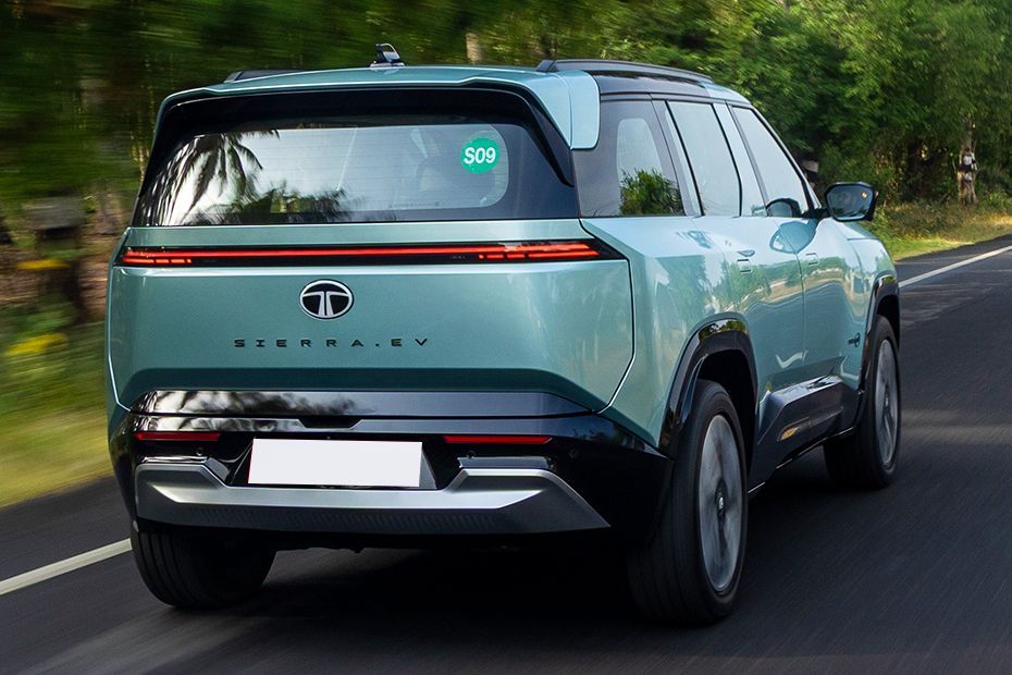 Driving: Rear Right Three Quarter View Image of Sierra EV